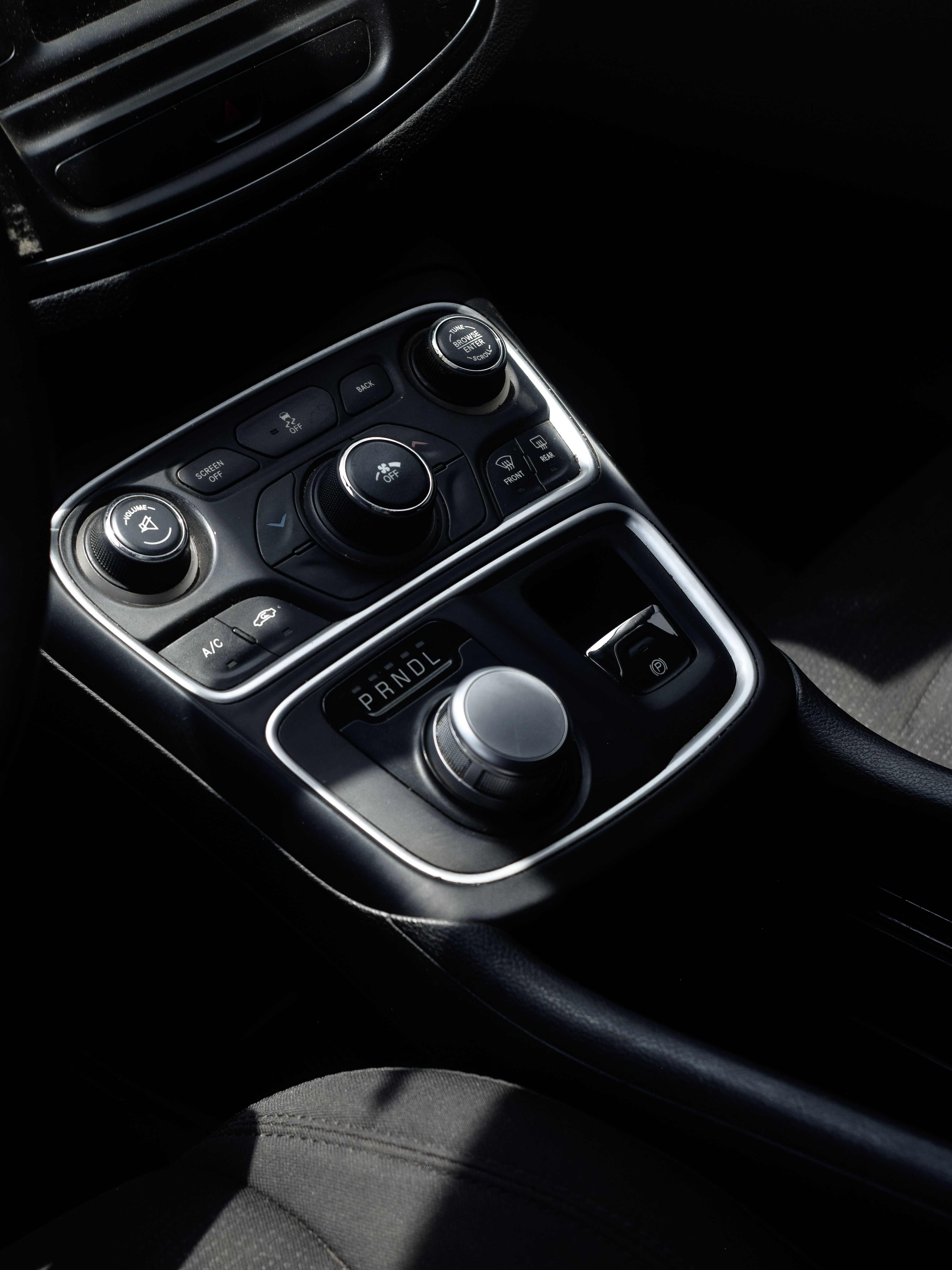 Modern vehicle center console with gear selector and in-cabin controls