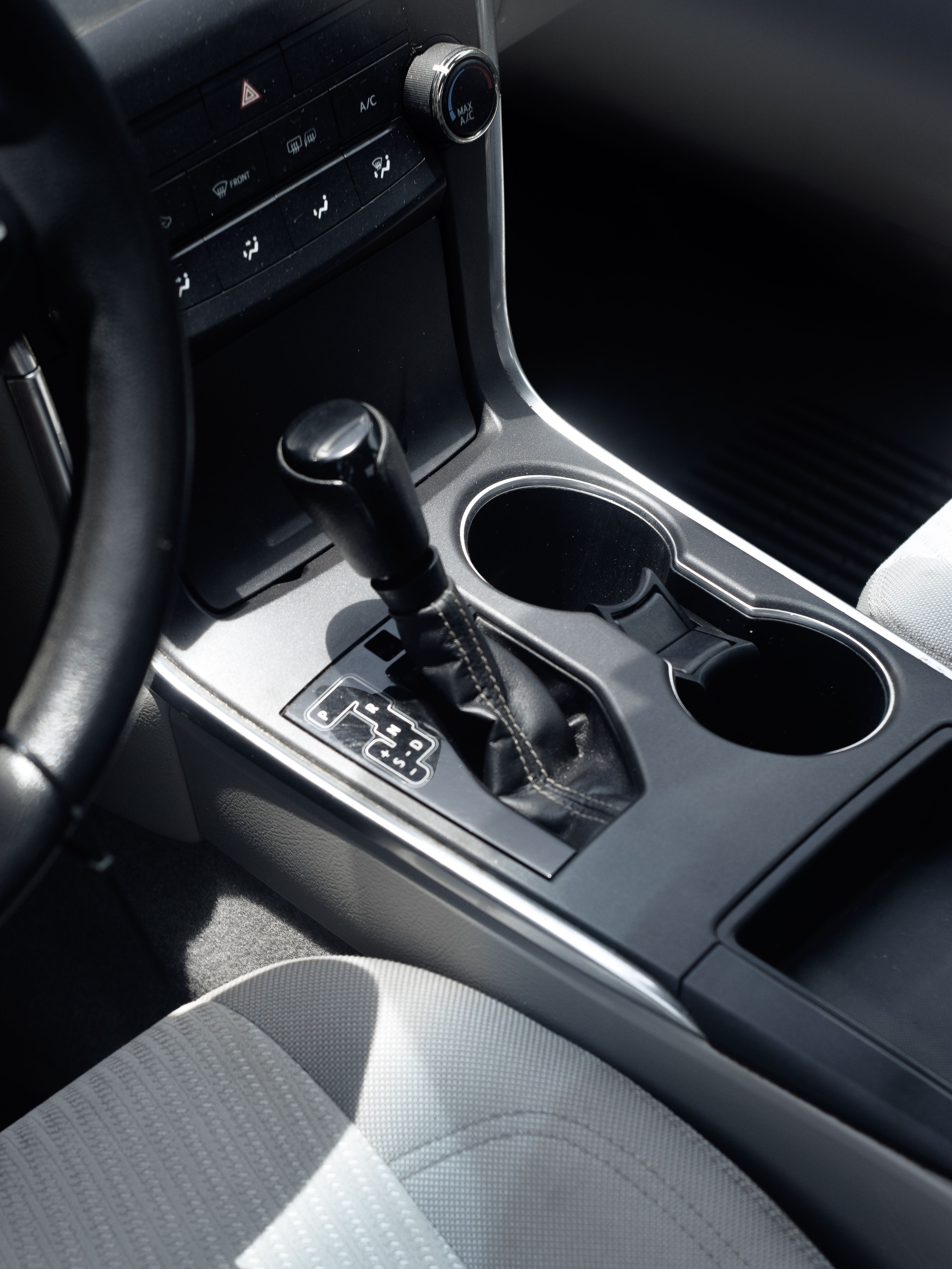 Modern car center console with gear selector and cup holders
