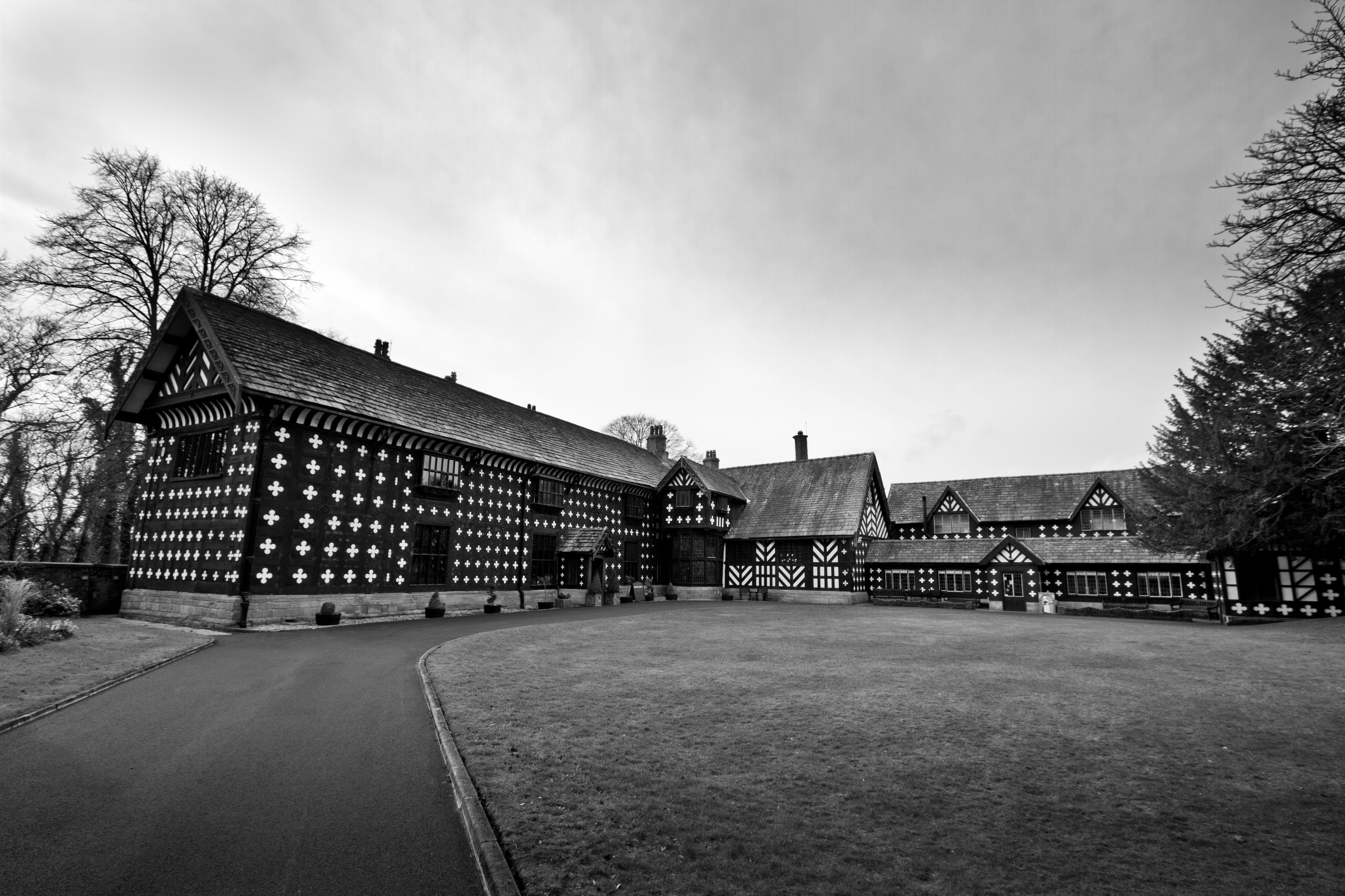 Explore the architectural beauty of Samlesbury Hall, England, in this striking monochrome image.