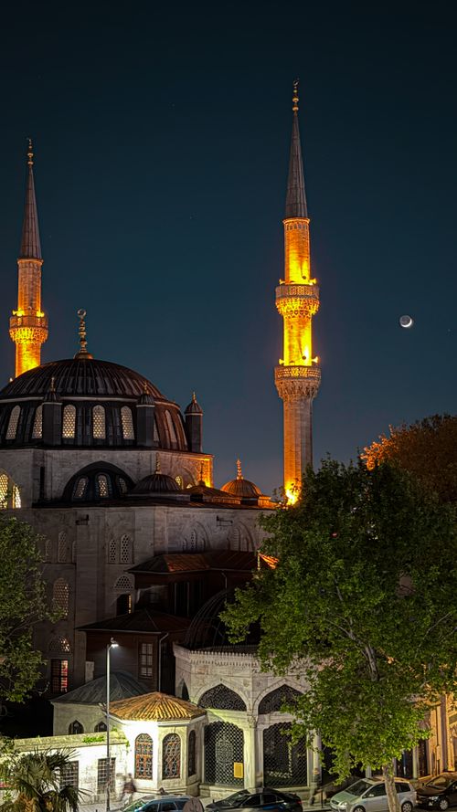 Free Illuminated Nuruosmaniye Mosque in Istanbul at night with a crescent moon in the sky. Stock Photo