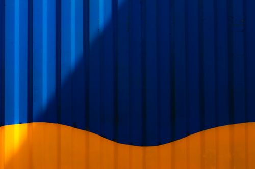 Free Bold abstract design with vivid blue and yellow colors, showcasing geometric shadows and striking contrasts. Stock Photo