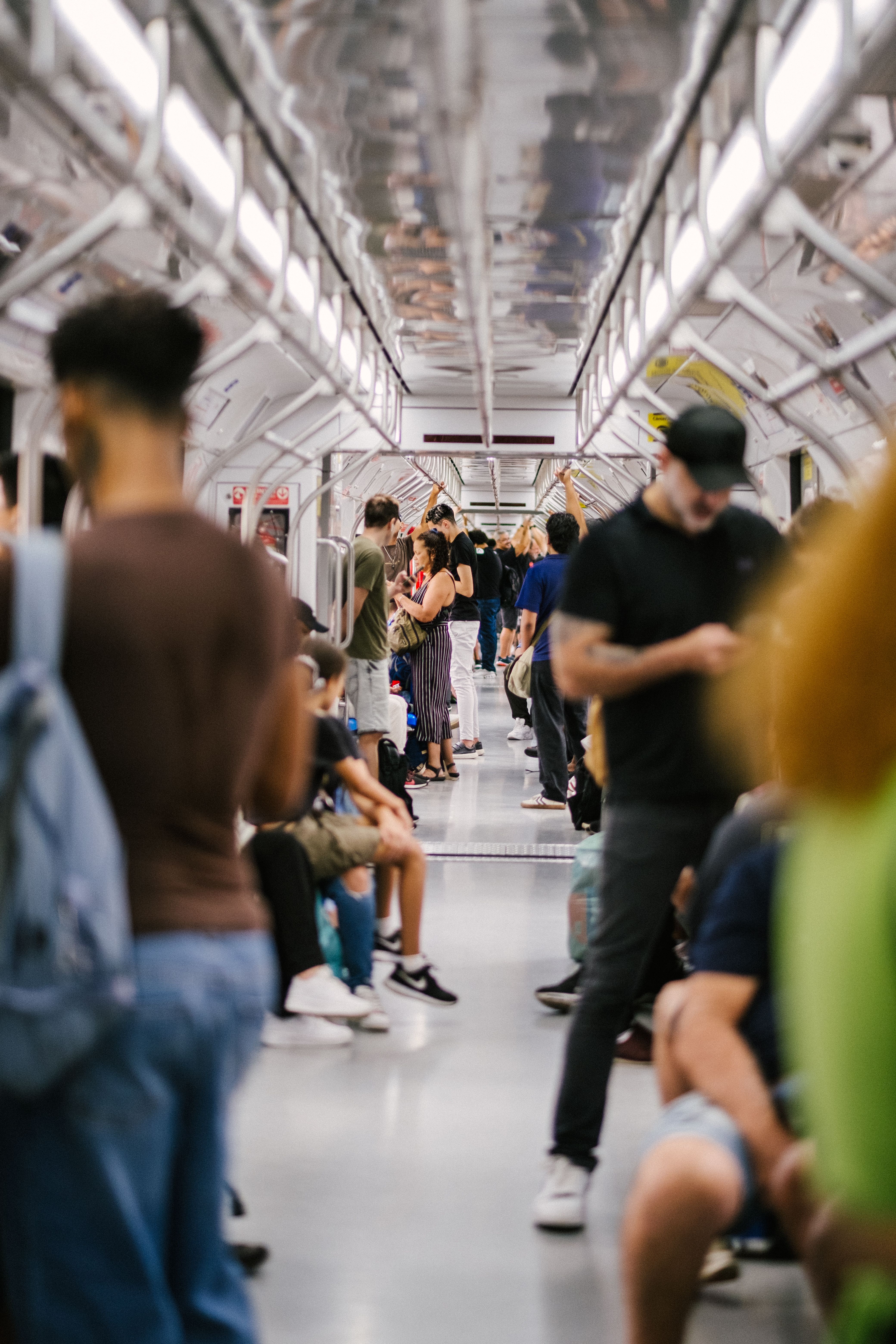 A bustling scene of diverse commuters inside a São Paulo subway train.