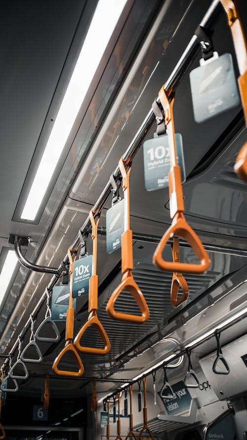 Free Hanging orange handles in public transport Stock Photo