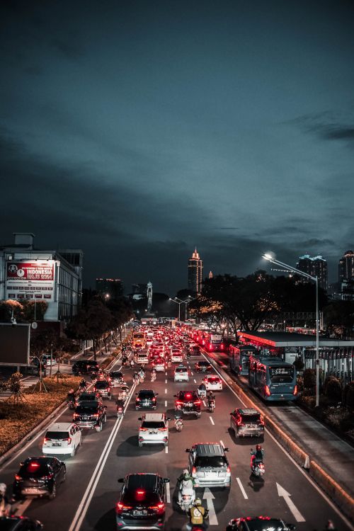 Free Various vehicles driving on asphalt street during traffic jam in modern city district in evening Stock Photo