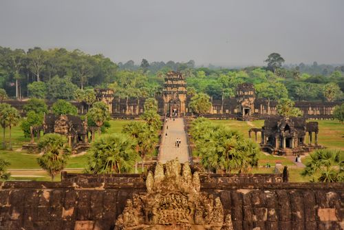 Free A breathtaking view of the historic Angkor Wat temple in Cambodia, surrounded by lush greenery. Stock Photo