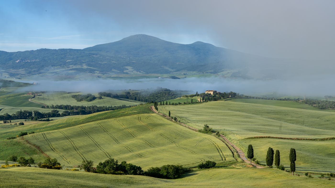 Rolling green hills and farmland at San Quirico d’Orcia in Tuscany, Italy