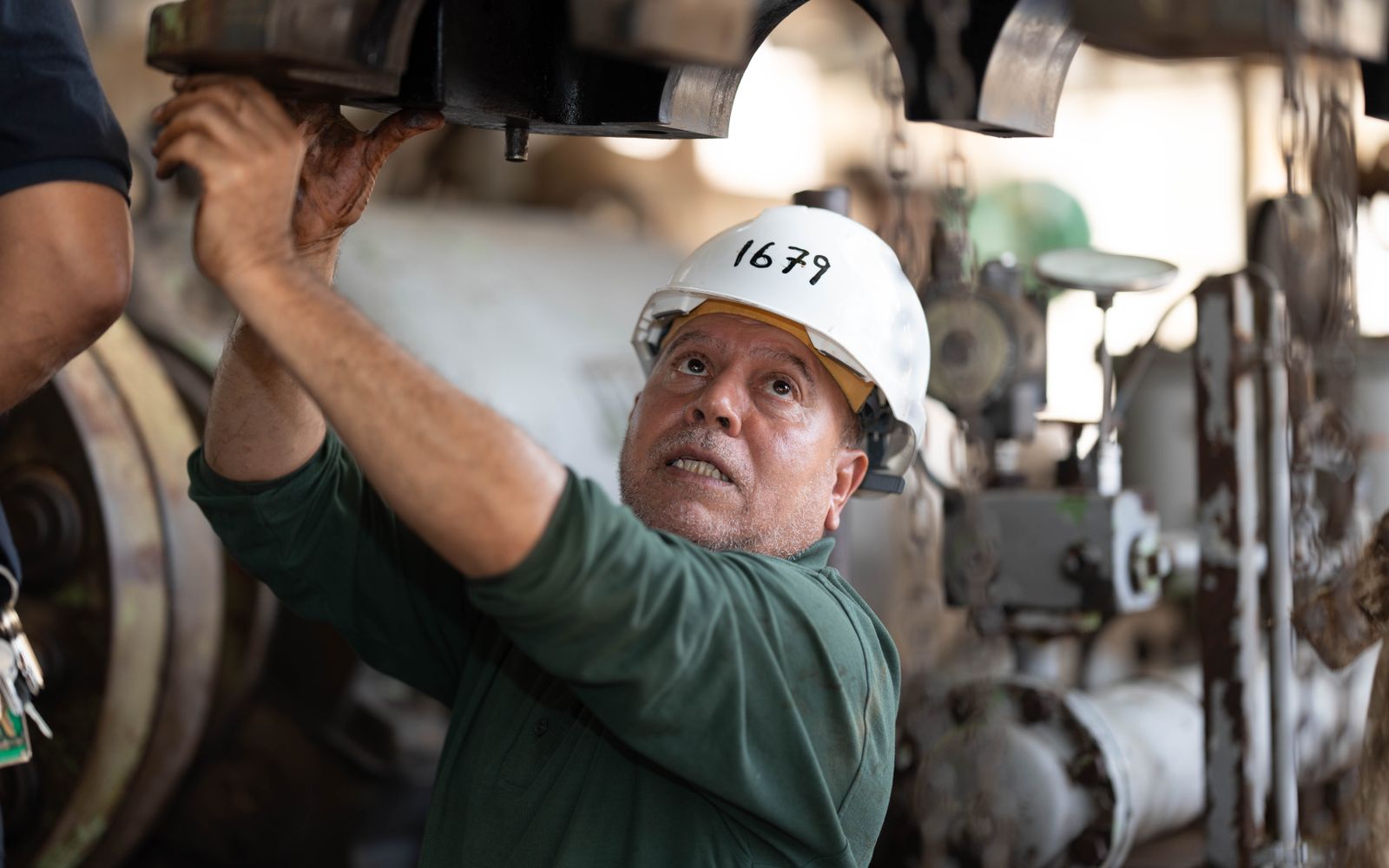 Engineer inspecting machinery for general technical building maintenance
