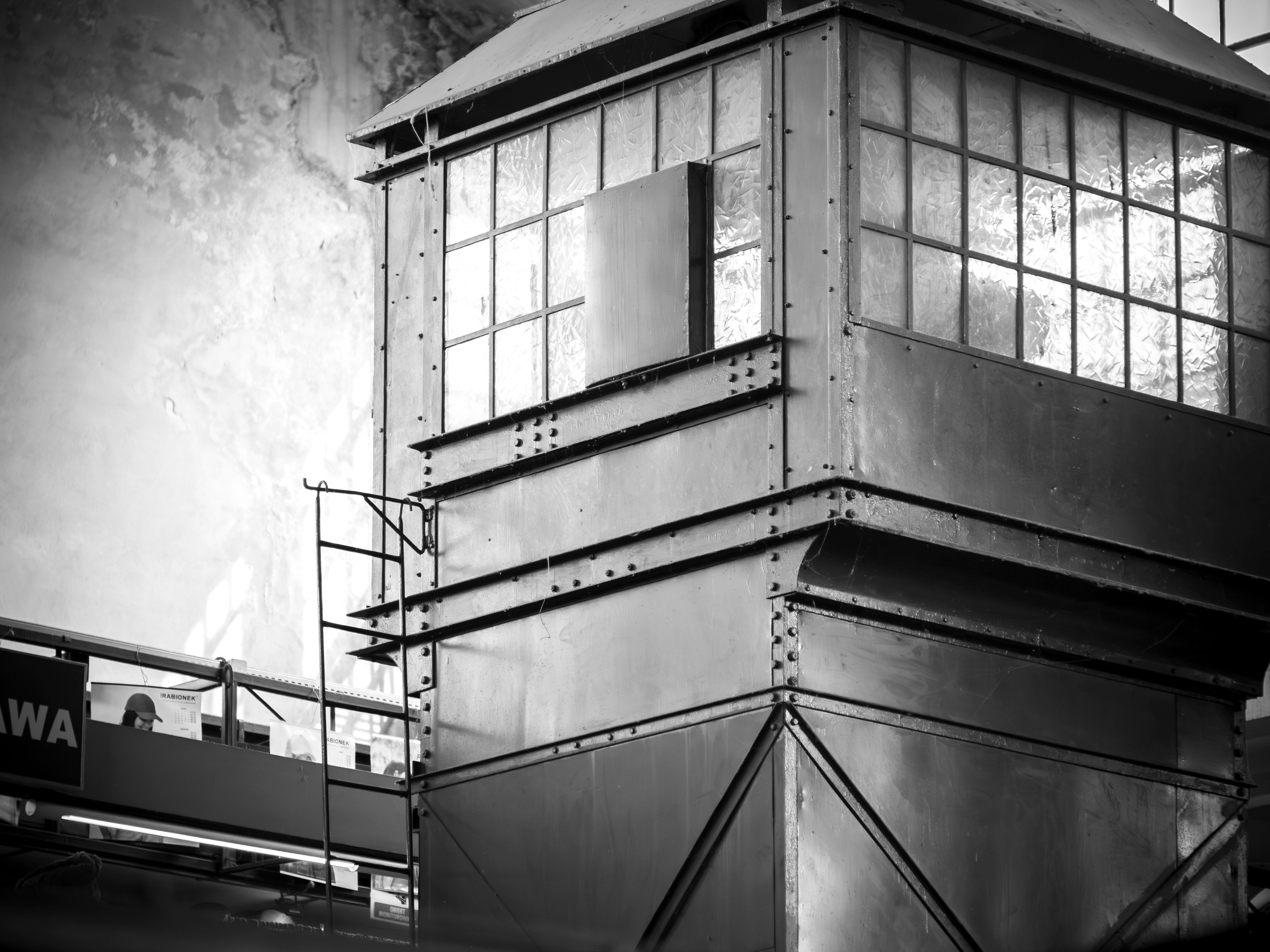 Monochrome image of an industrial metal structure with windows in Poland.