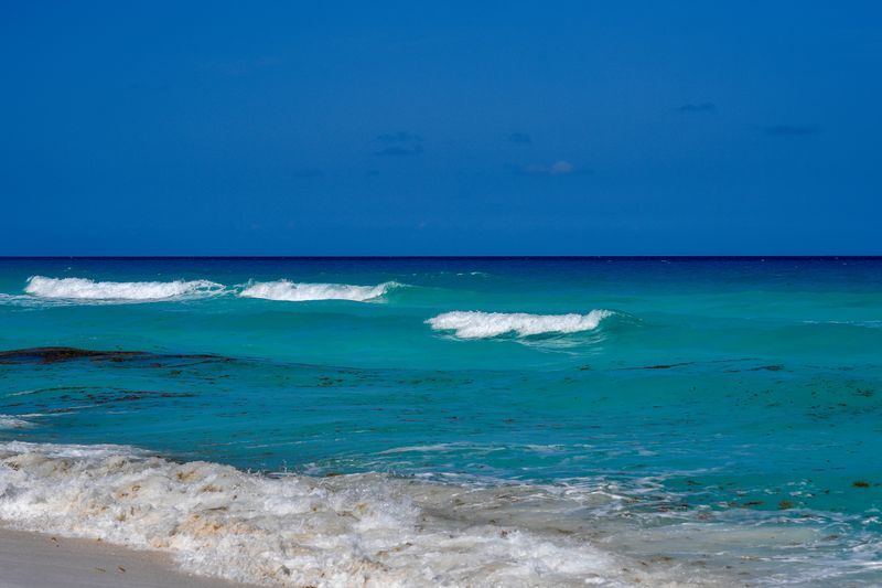 Turquoise waves rolling onto a Cancun beach in Mexico