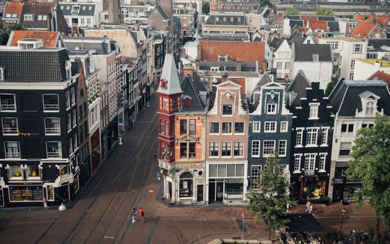 Aerial view of historic Amsterdam canal district showcasing colorful Dutch row houses and quaint streets.