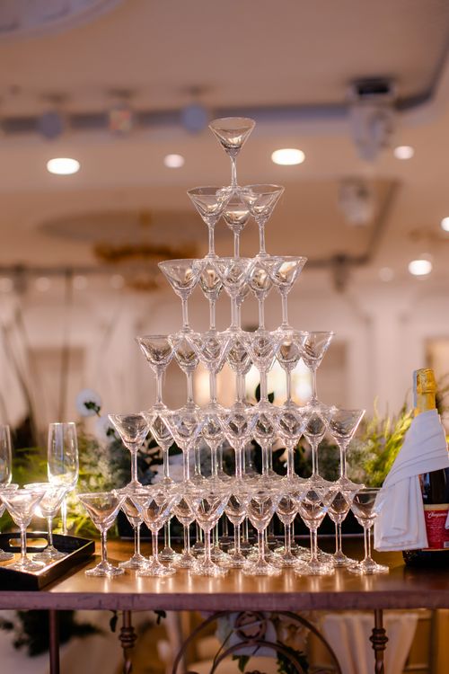 Free Beautiful champagne glass pyramid set up at a stylish event indoors. Perfect for celebrations. Stock Photo