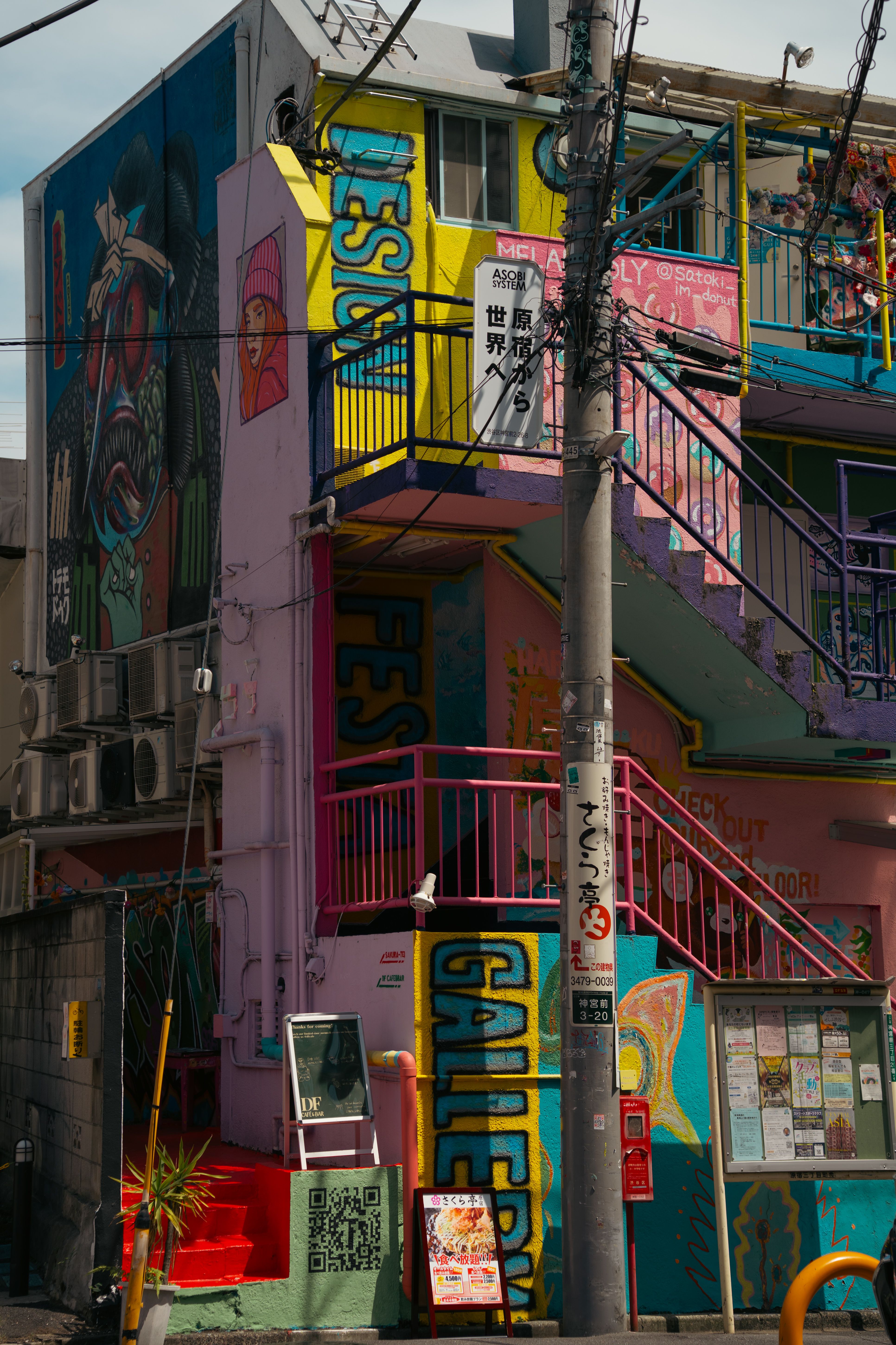 Vibrant street art adorns an urban building, showcasing Tokyo's creative expression.