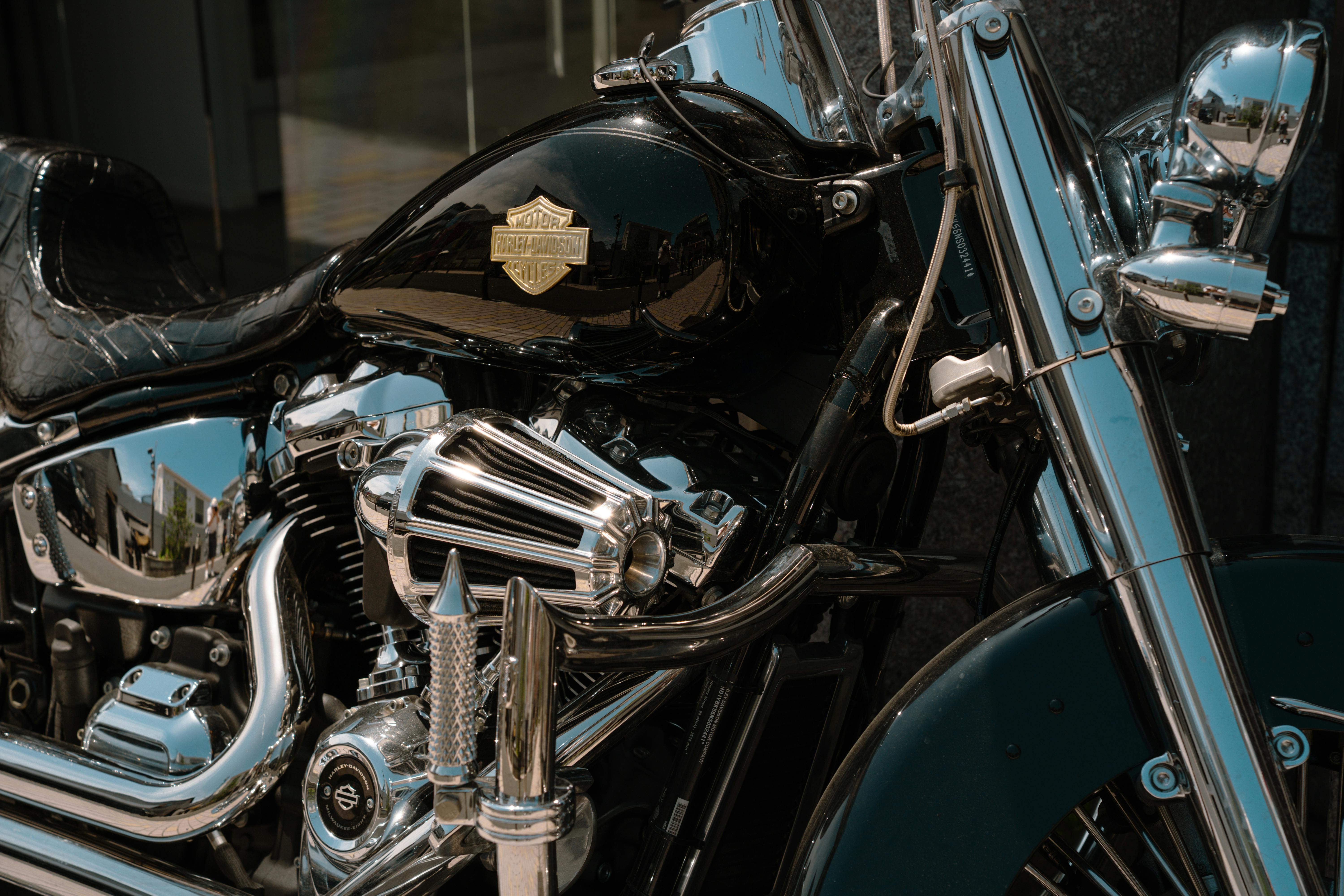 Detailed view of a chrome motorcycle engine under sunlight in Tokyo, Japan.