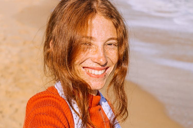 Portrait Photo Of Smiling Woman With Freckles Standing By The Beach