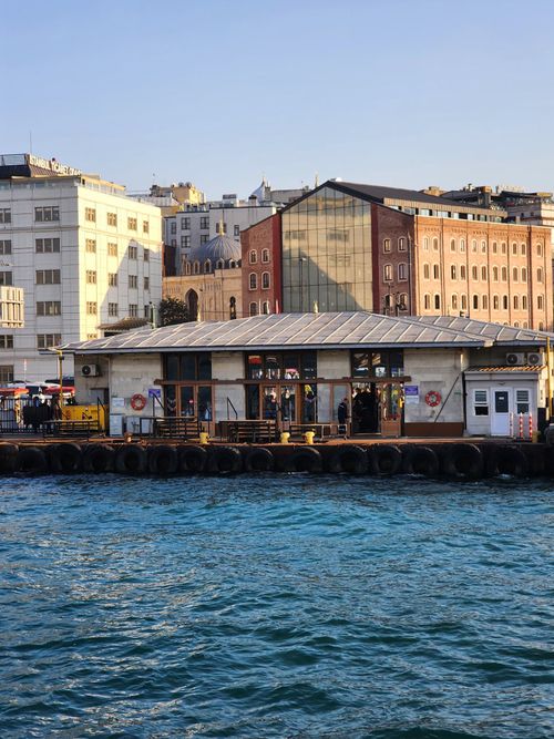 Free Charming waterfront scene in Istanbul featuring historic buildings and vibrant city life. Stock Photo
