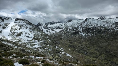Free Majestic snow-capped mountain range under cloudy skies in Castile and León, Spain. Stock Photo
