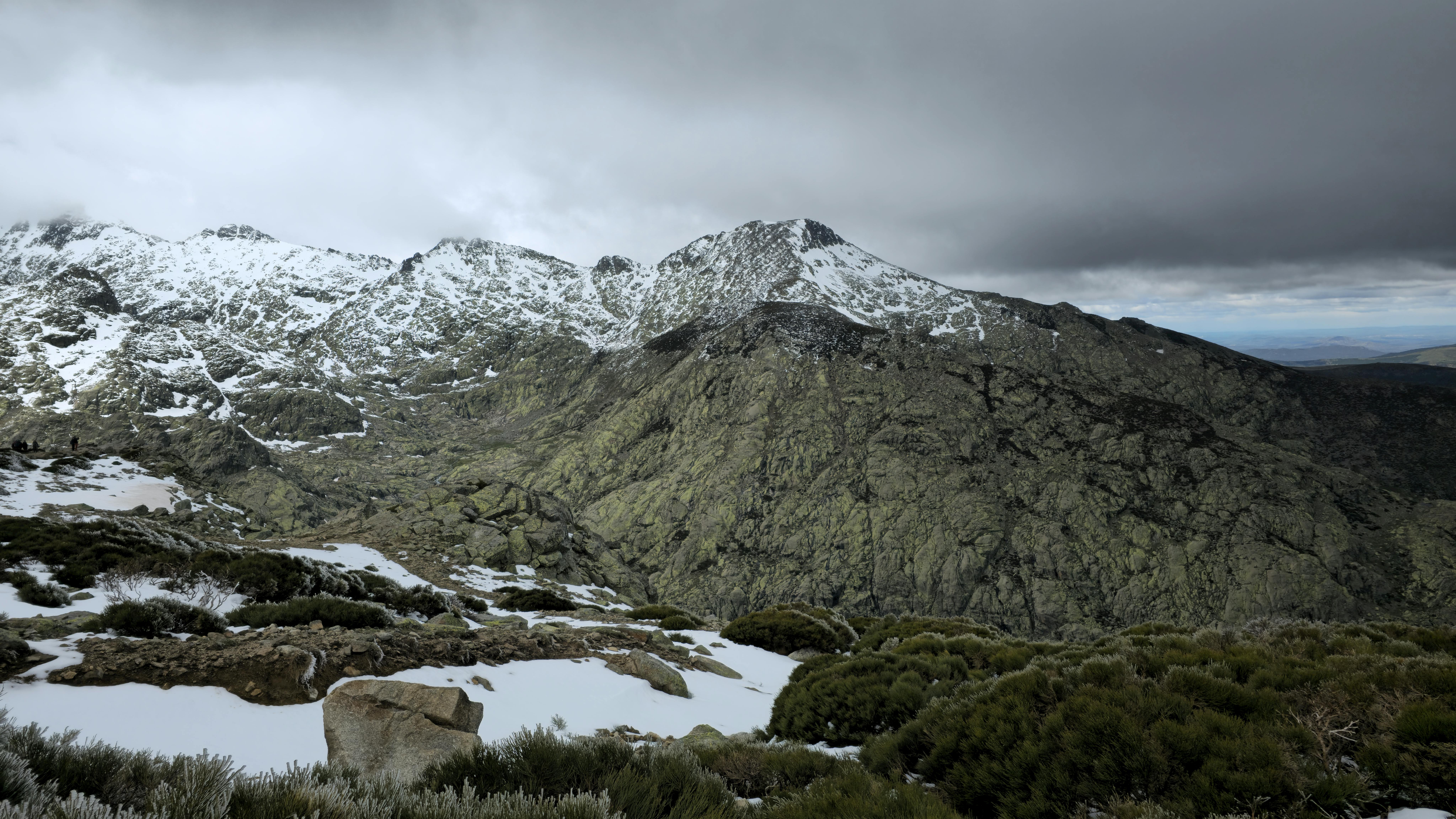 Majestic snow-capped mountain landscape in Castile-León, Spain, under moody skies.