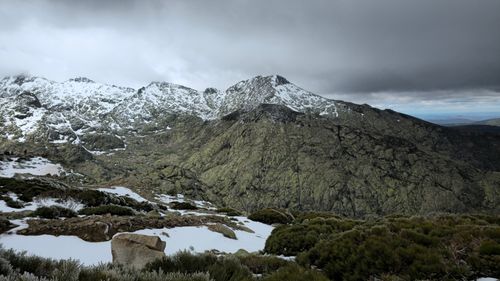 Free Majestic snow-capped mountain landscape in Castile-León, Spain, under moody skies. Stock Photo