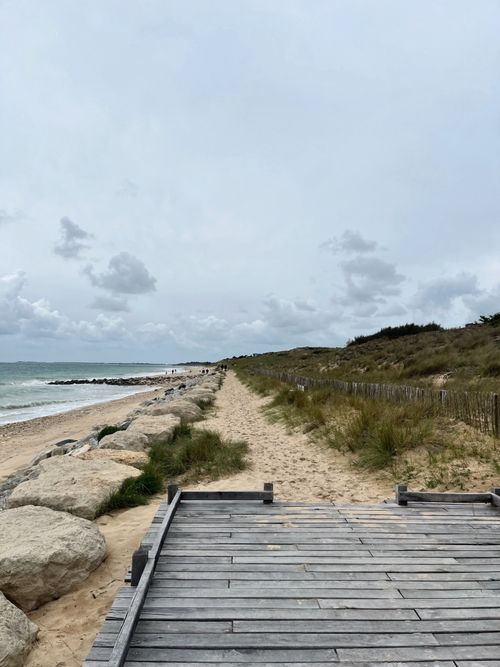 Free Explore the serene sandy beach and coastal pathway in Nouvelle-Aquitaine, France. Stock Photo