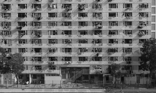 Free Monochrome photo of a high-rise apartment building with many windows and balconies. Stock Photo