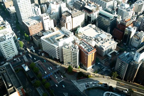 Free High-angle view of a bustling cityscape featuring large buildings and busy roads. Stock Photo