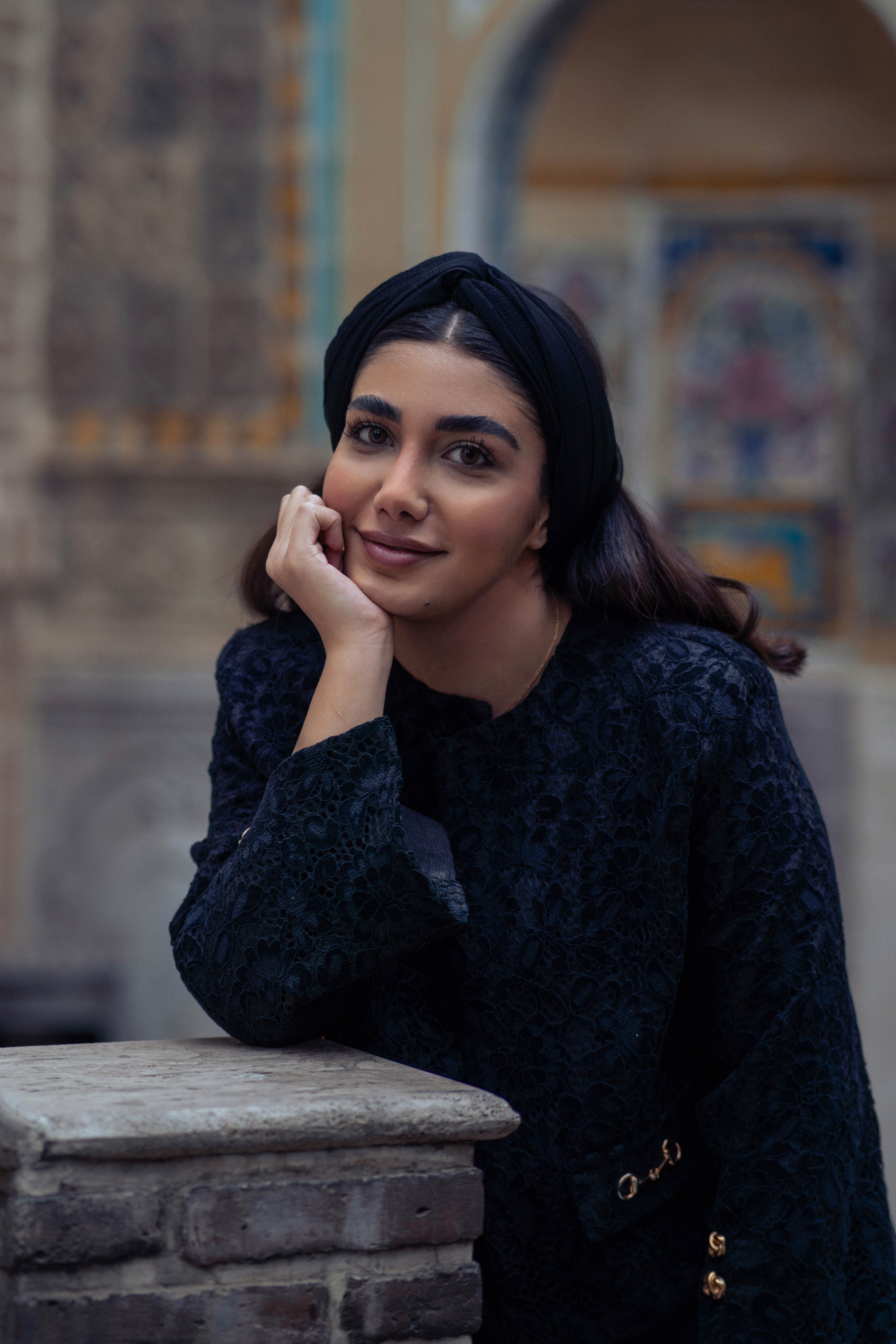 Portrait of a woman posing with a smile in Tehran, showcasing Middle Eastern beauty.