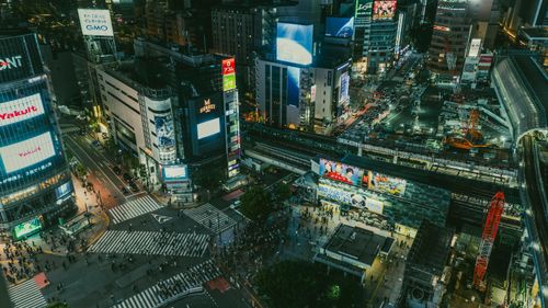 Free Aerial view of the bustling Shibuya Crossing in Tokyo at night, full of life. Stock Photo