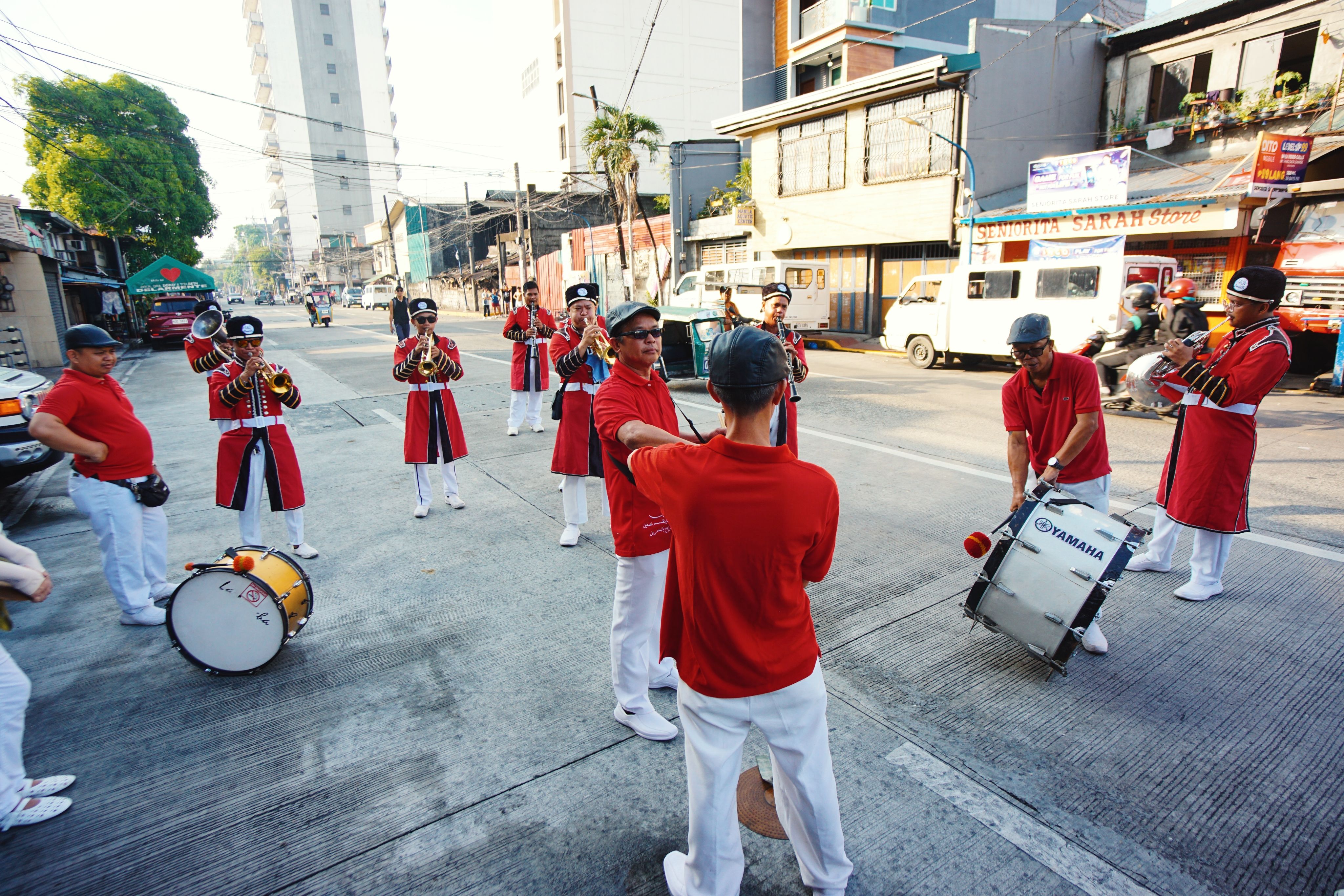 Street Parade with Marching Band in Urban Setting · Free Stock Photo