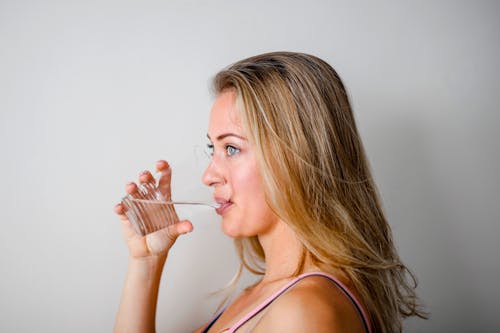 Photo of Woman Drinking from Plastic Cup