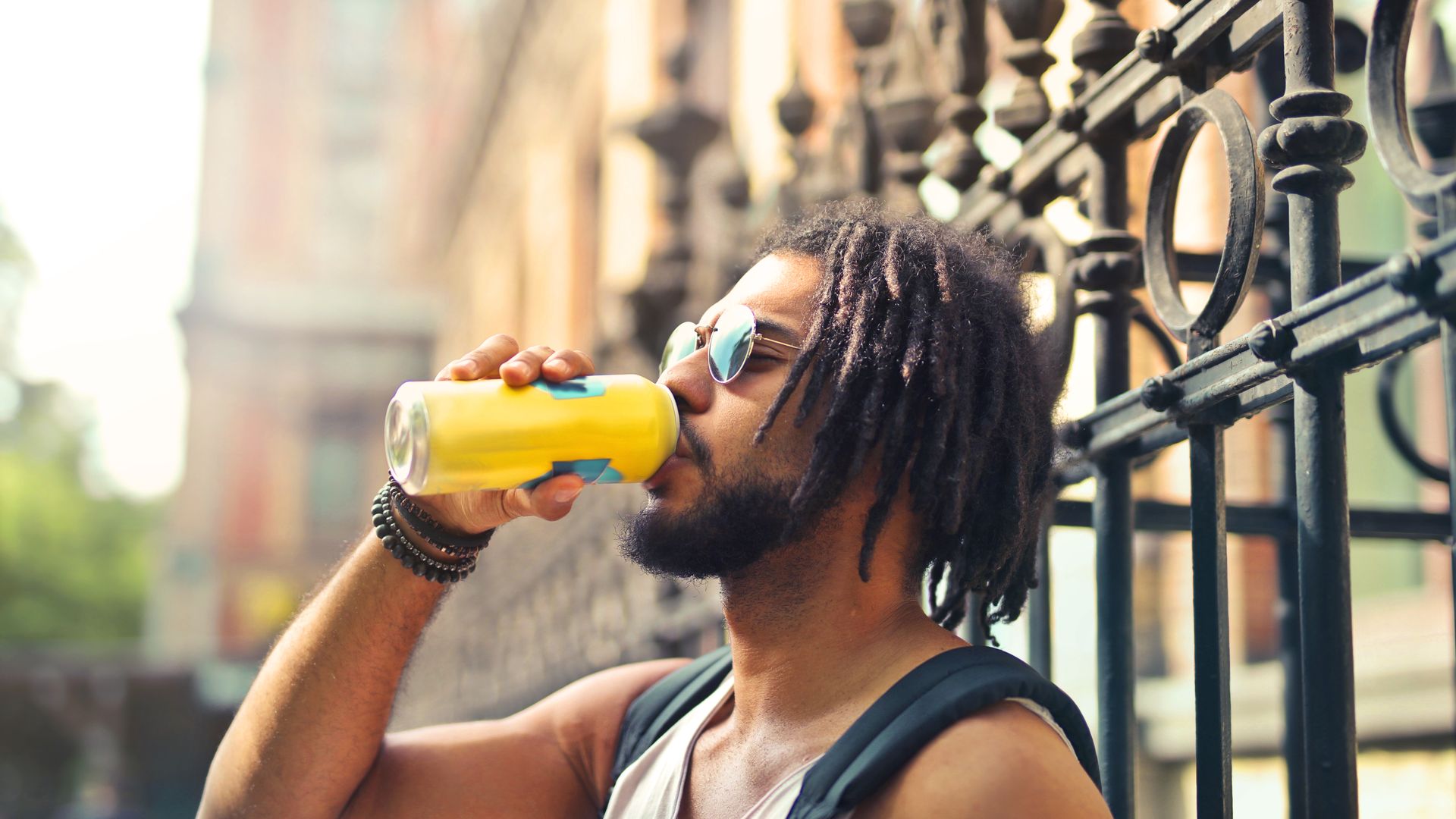 Why Does Modafinil Make You Thirsty: Understanding the Mechanism Young man with dreadlocks enjoys a canned drink outdoors — why does modafinil make you thirsty