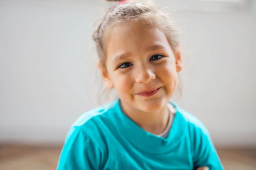 Girl Wearing Teal Crew Neck T-shirt While Smiling