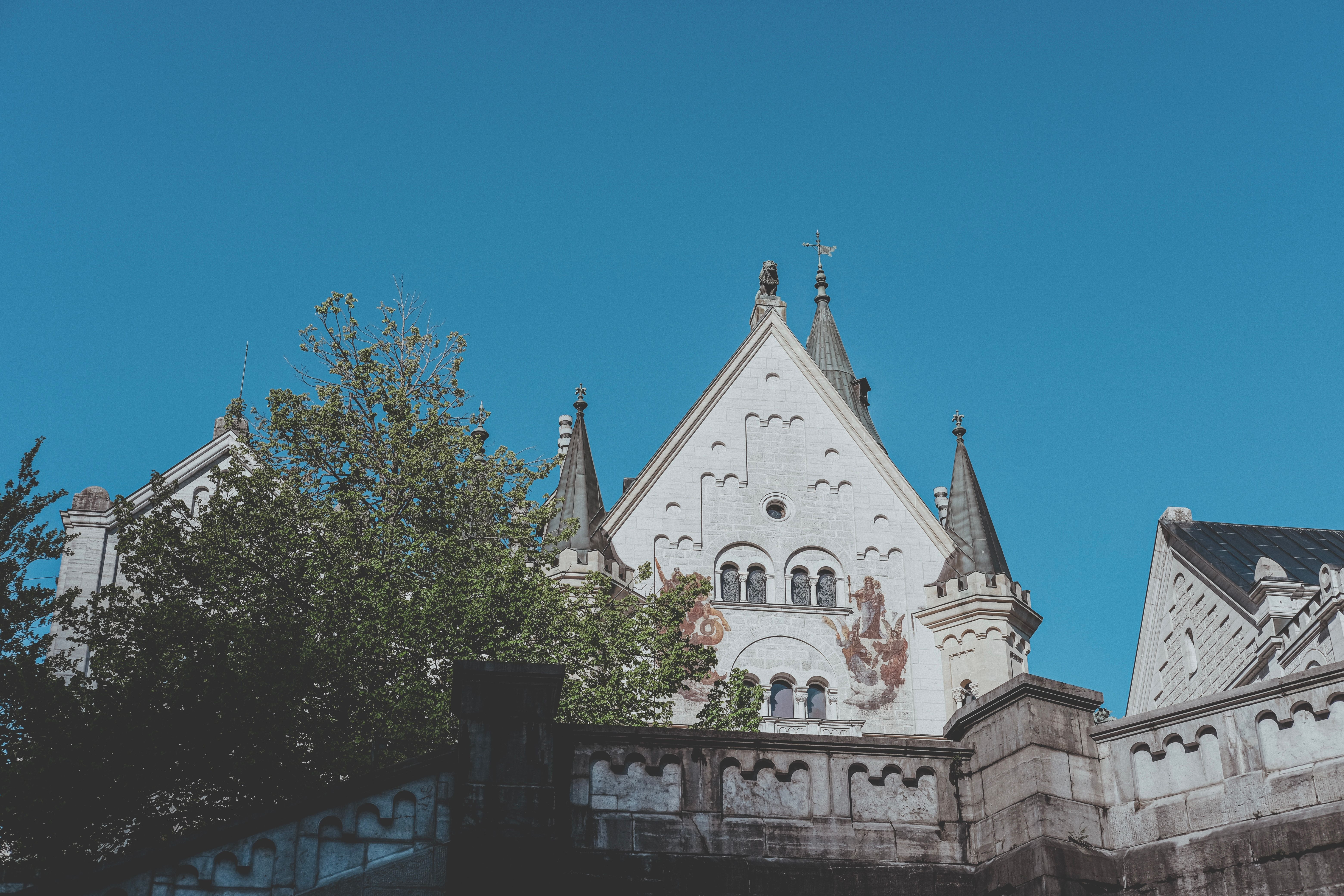Historic Gothic Building with Spires Under Blue Sky · Free Stock Photo