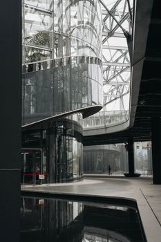 Interior view of a sleek modern building with glass reflections in China. Urban elegance meets innovative architecture.