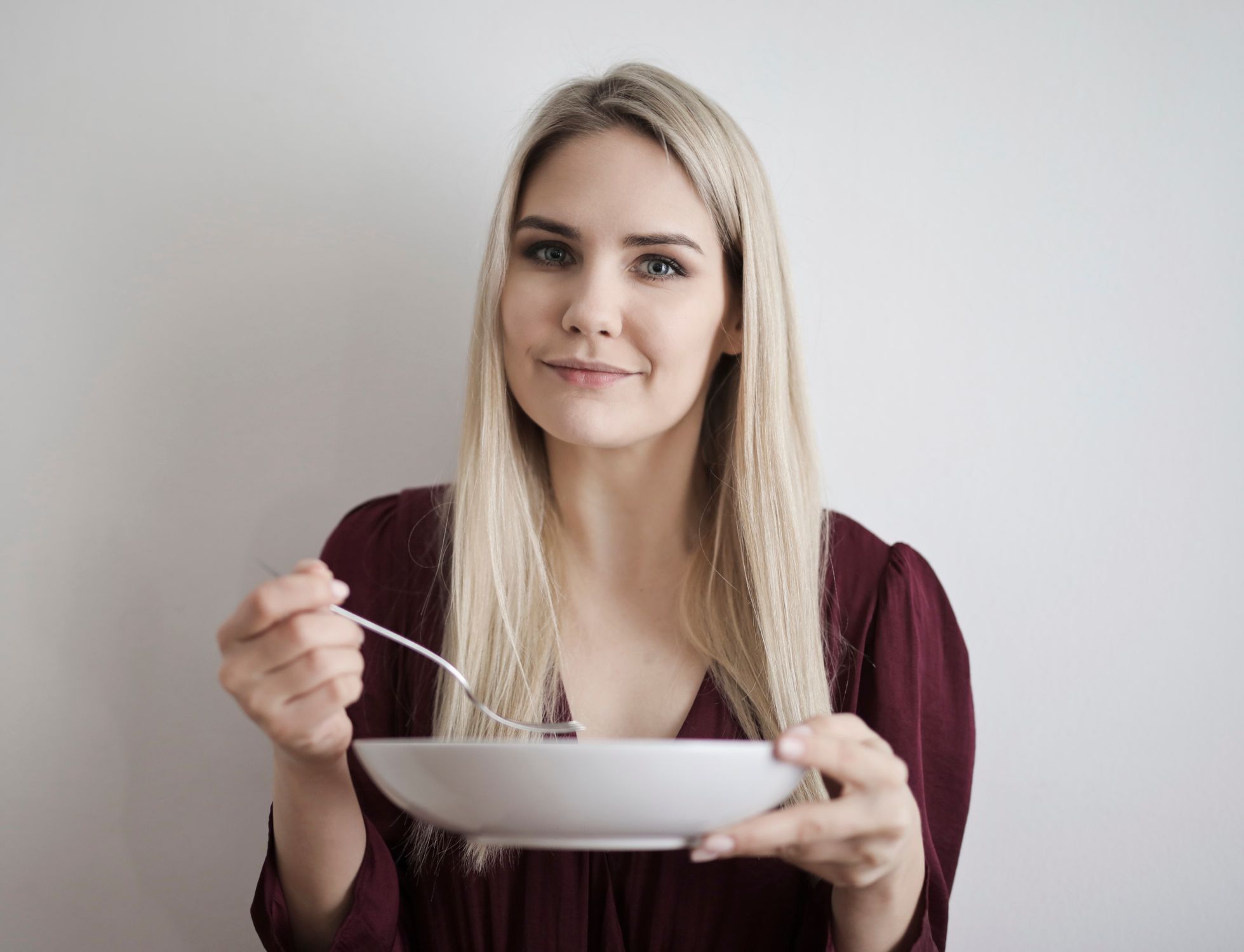 Mulher segurando uma tigela de alimentos saudáveis, representando a diversidade alimentar e o cuidado com a microbiota