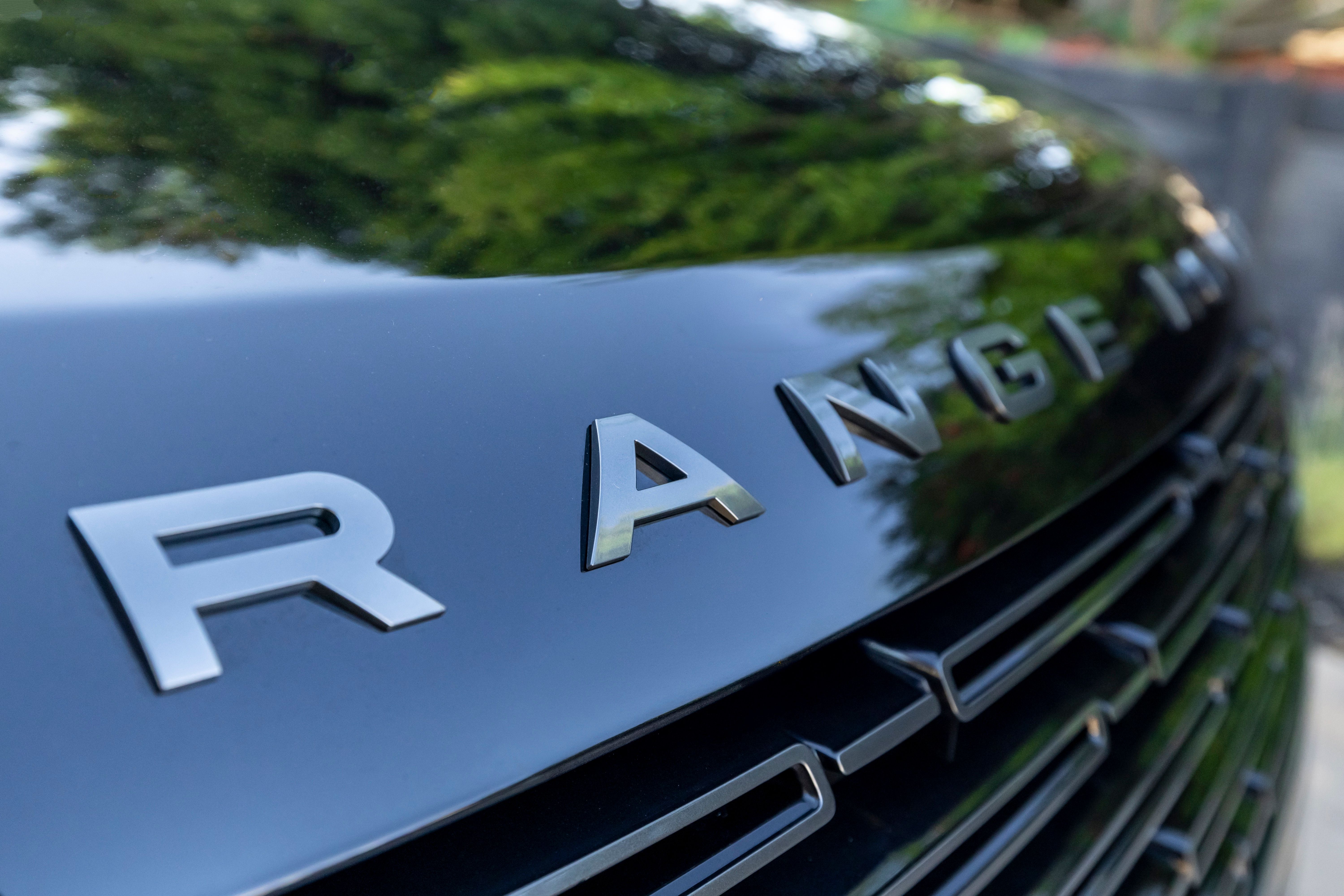 Detailed view of a Range Rover grille showcasing the elegant design of the vehicle.
