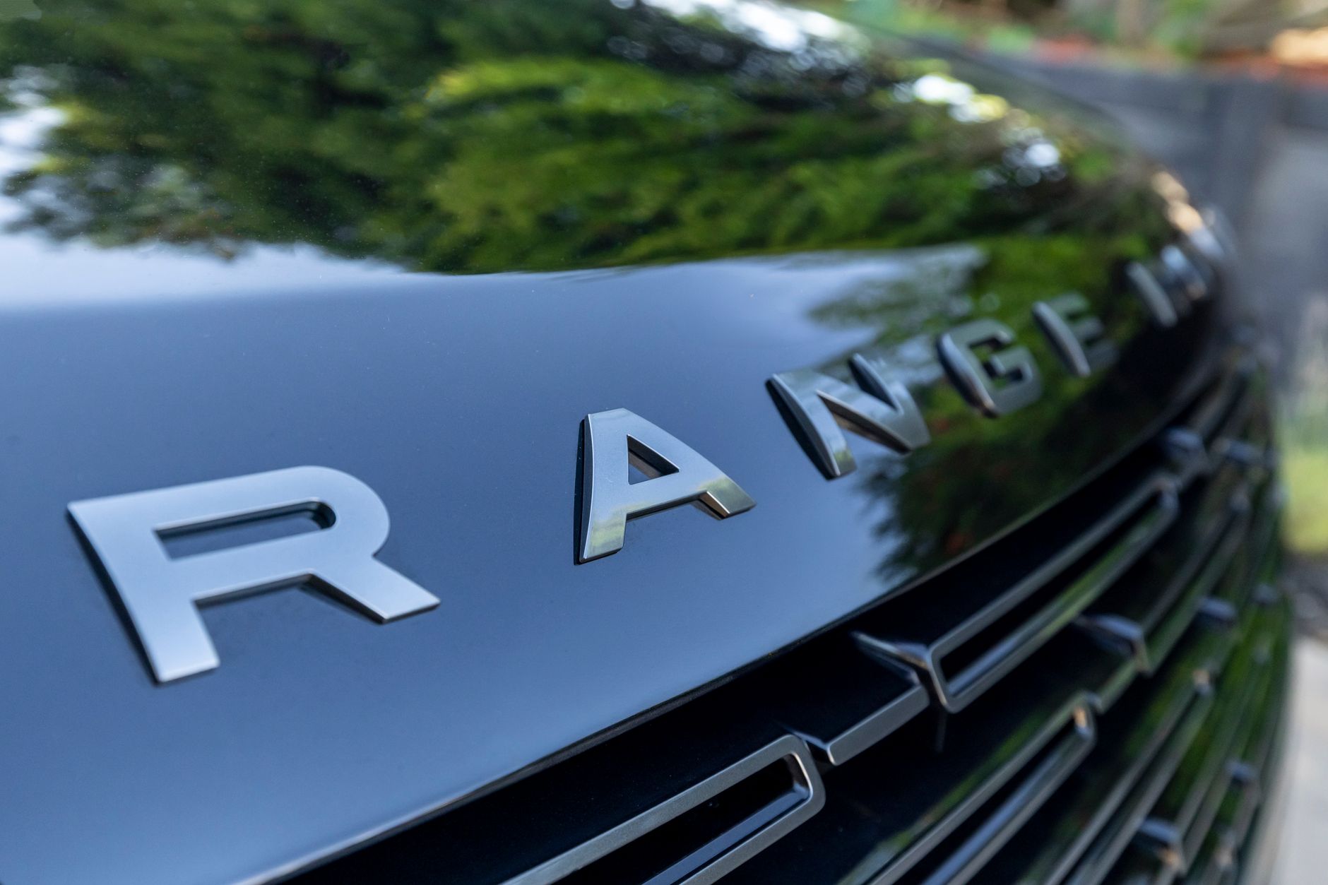 Detailed view of a Range Rover grille showcasing the elegant design of the vehicle.