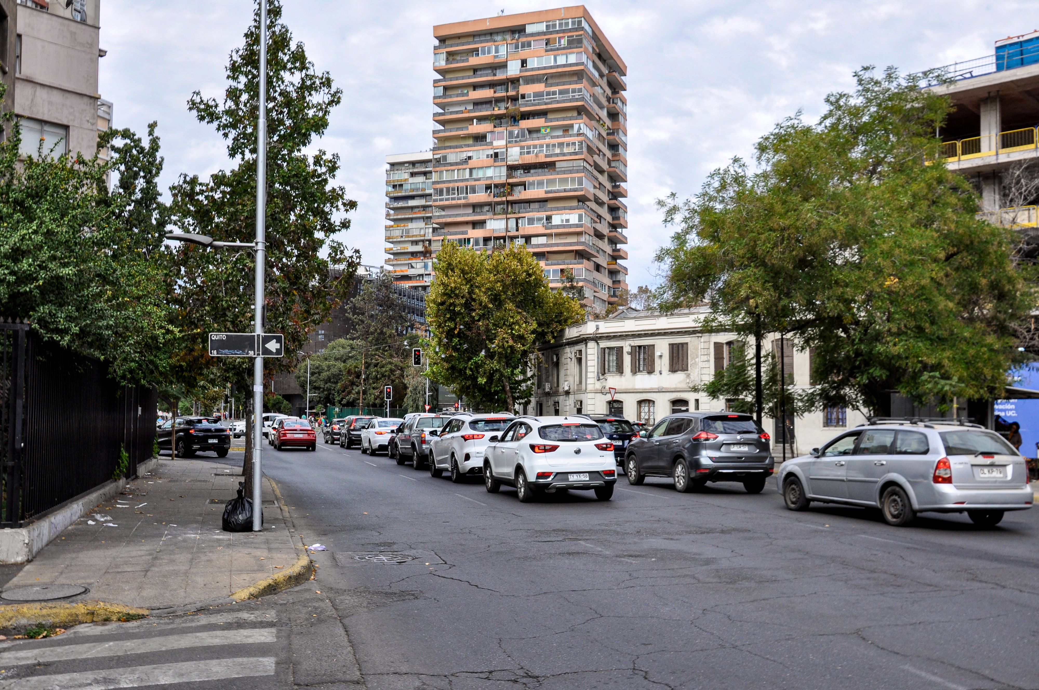 Busy urban street scene in Santiago, Chile featuring traffic and high-rise buildings.