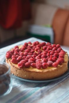 A freshly baked raspberry cheesecake on a table, rich and inviting.