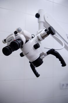Close-up of a modern surgical microscope in a healthcare facility.