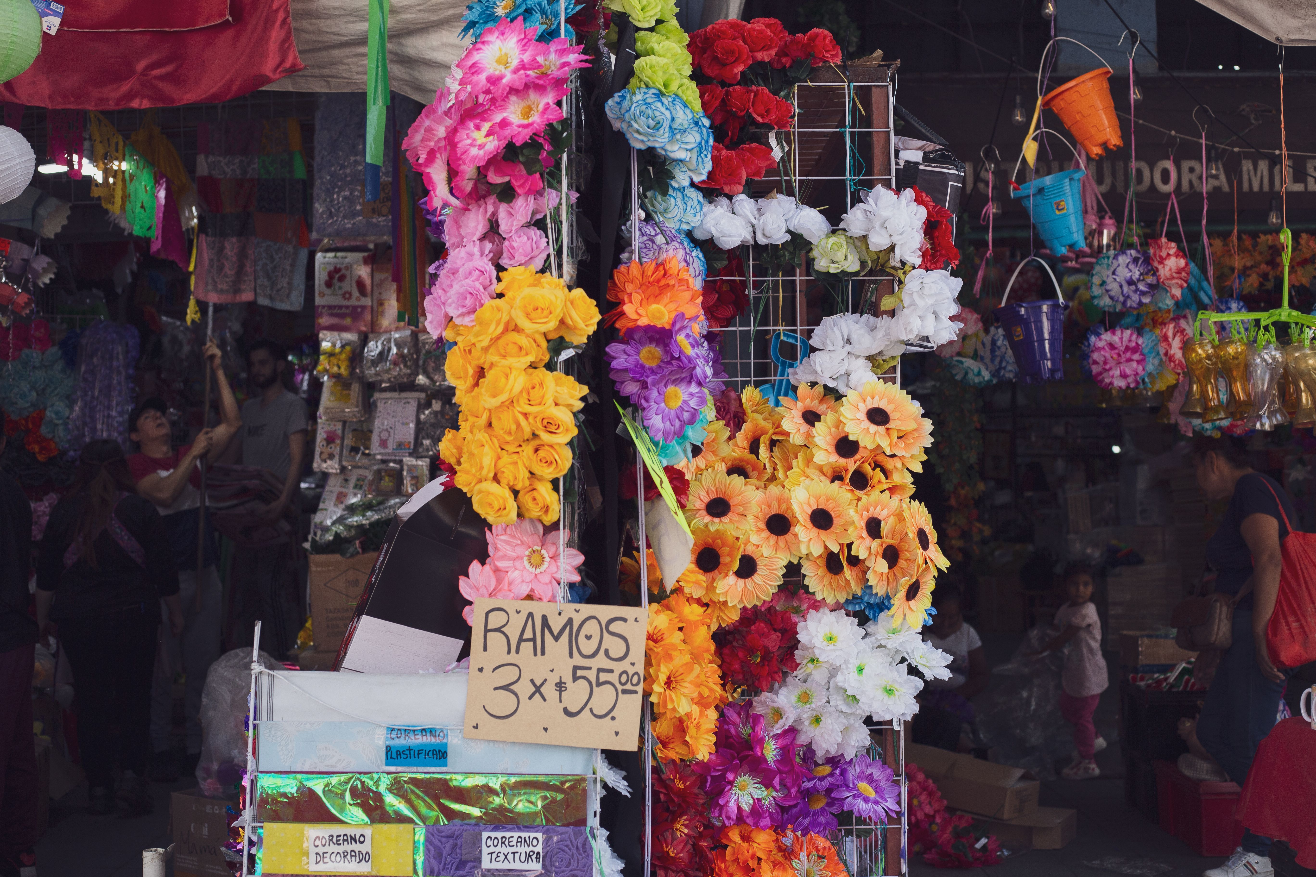 Colorful flower arrangements at a bustling Mexico City market showcasing vibrant hues and lively street scenes.