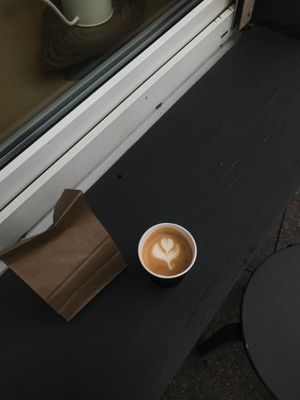Coffee cup and pastry bag ready for handoff — photo by Veronika Latysheva on Pexels