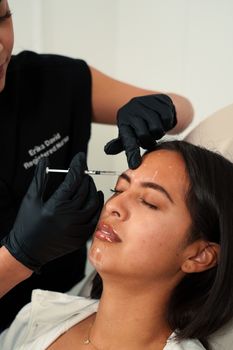 Woman receiving botox injection at a med spa, showcasing a cosmetic procedure.