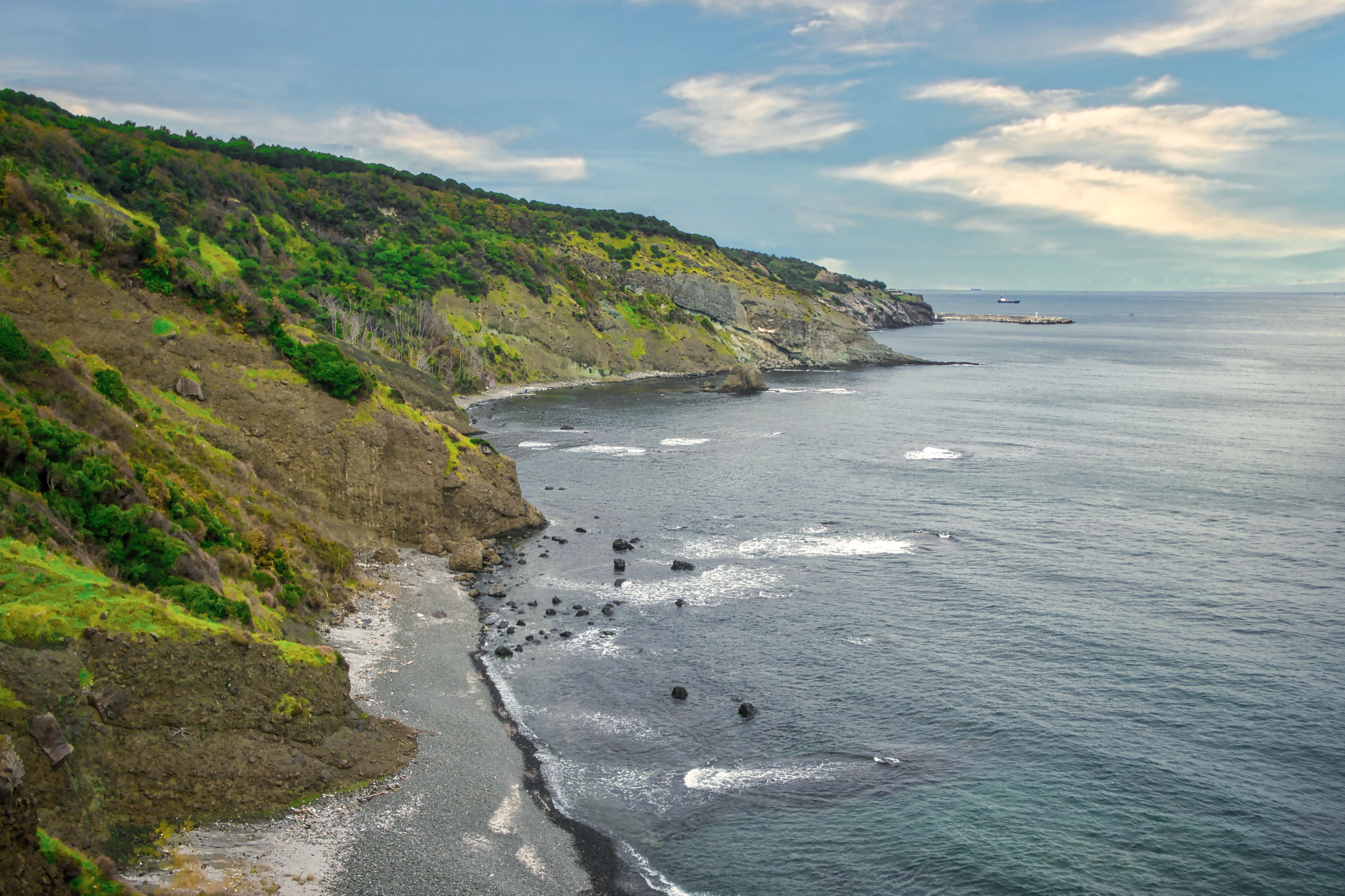 Scenic Coastal View with Rocky Shoreline · Free Stock Photo