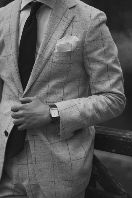 Free Black and white photo of a man in a sophisticated plaid suit and watch. Stock Photo