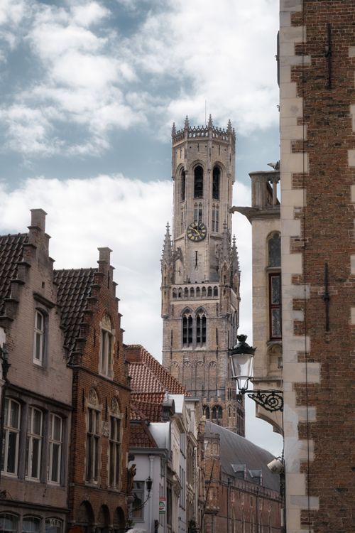 Free The iconic Belfry Tower of Brugge captured against a cloudy sky, showcasing medieval architecture. Stock Photo