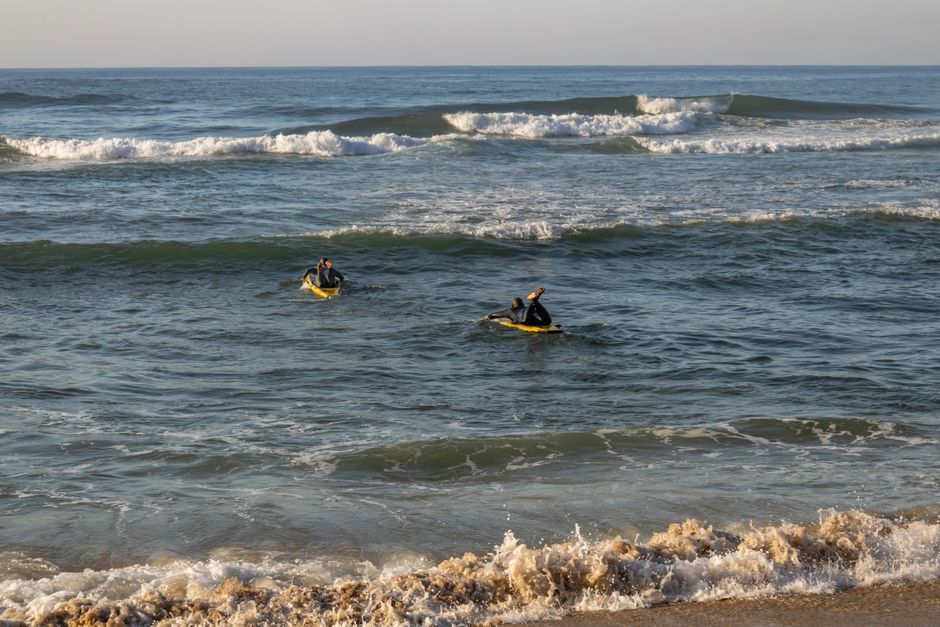 Lifeguards practicing surf training on the Indian Ocean waves at Margate Beach, South Africa.