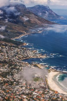 Breathtaking aerial view of Cape Town's scenic coastline with mountains and ocean.
