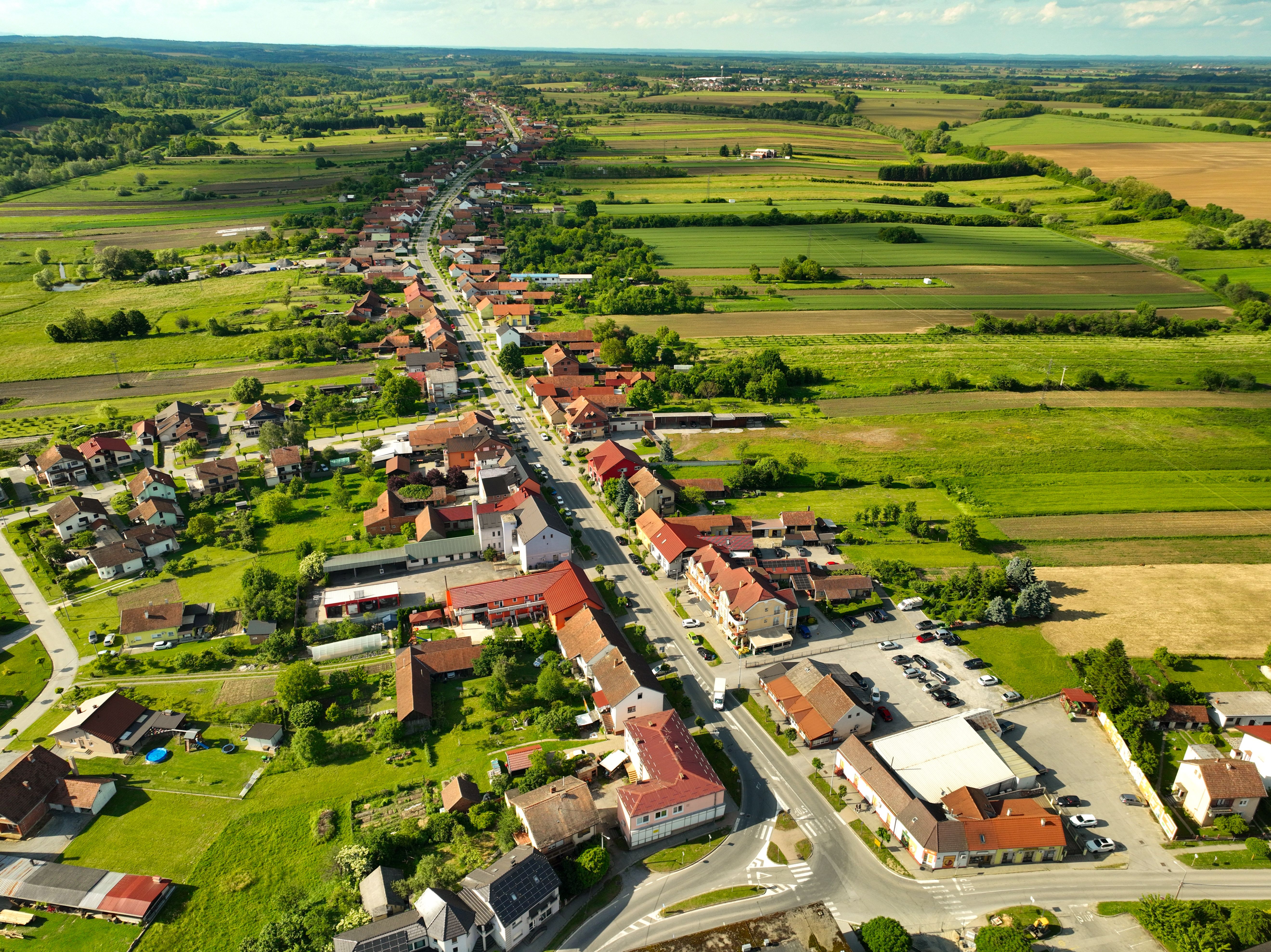 Stunning aerial view of the quaint town of Garešnica, showcasing lush green countryside and winding roads.