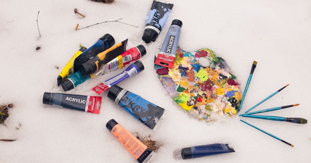 Acrylic paint tubes, brushes and a mixed palette