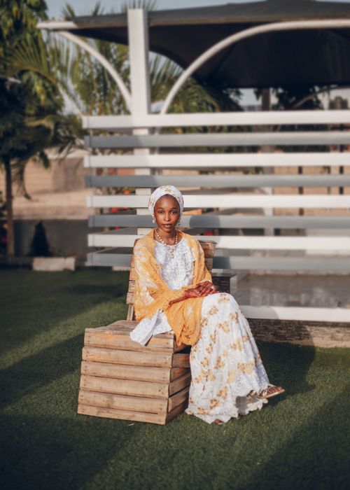 Free Portrait of a young Nigerian woman in elegant traditional dress outdoors. Stock Photo